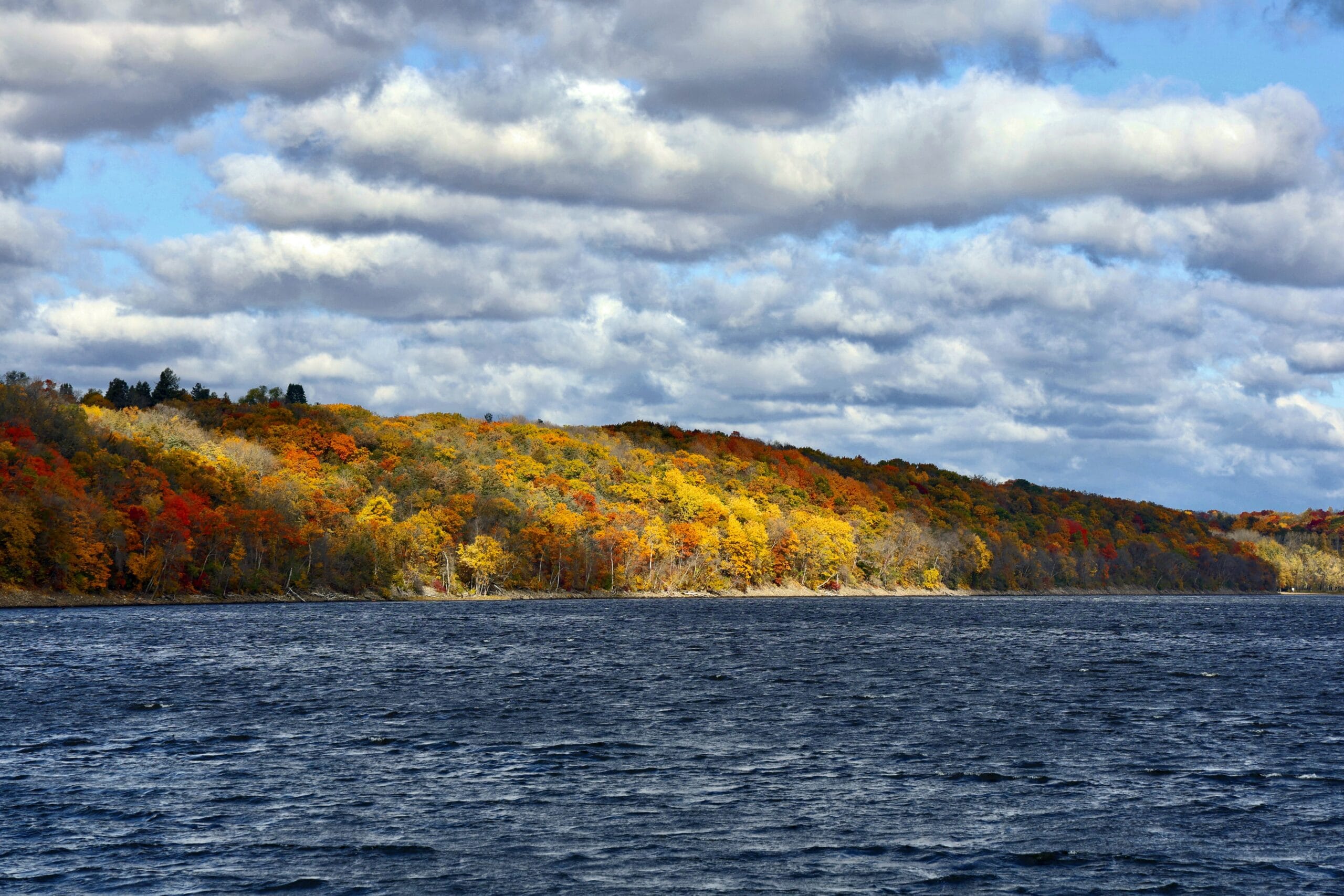 River with yellow, red, and green fall trees