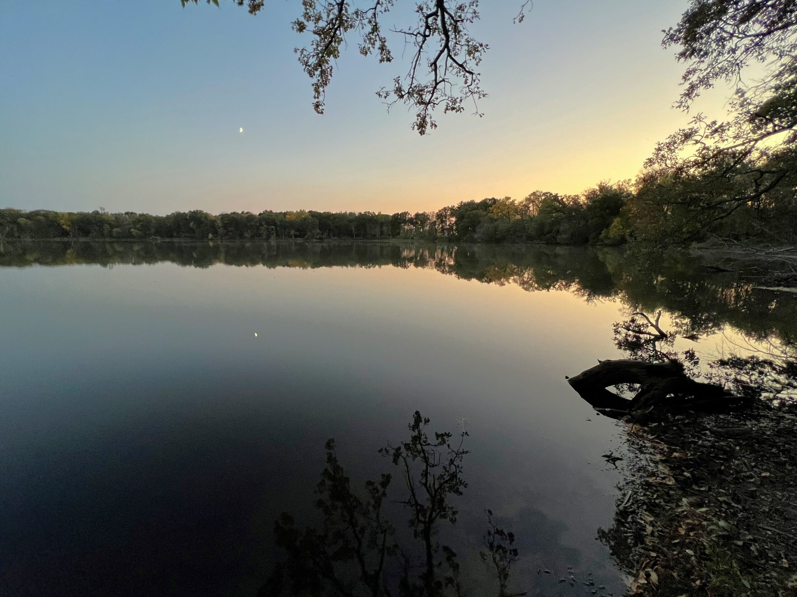 Sunset reflecting on the water of a still lake